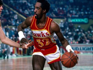 Dan roundfield in his hawks jersey driving to the basket young