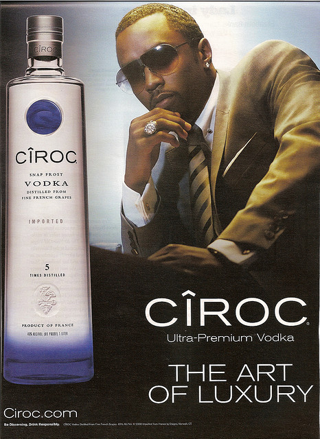 diddy in a suit sitting a bottle of ciroc pictured with verbiage underneath
