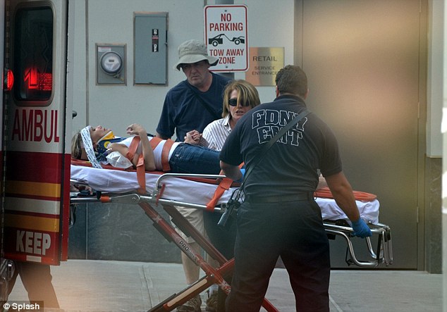 Kristin chenoweth jeans and t shirt strapped to a gourney being loaded in ambulance