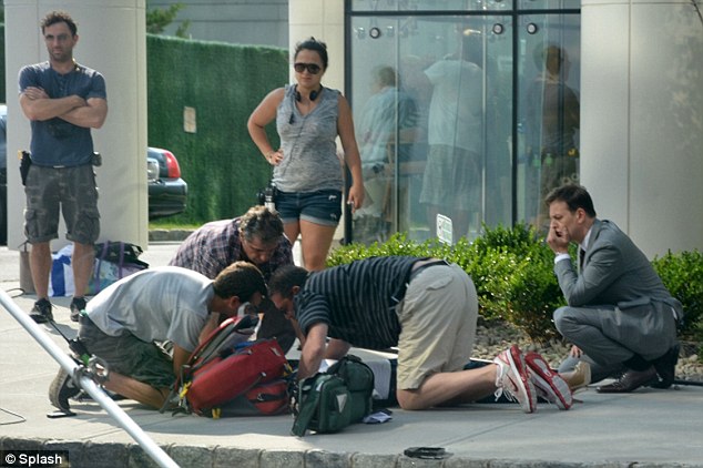 kristen Chenoweth, on ground, 3 men kneeling over her and paramedics