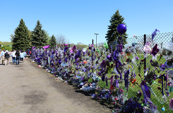 Tributes and memorials dedicated to Prince on the fence that surrounds Paisley Park on May 2, 2016 Credit: Adam Bettcher